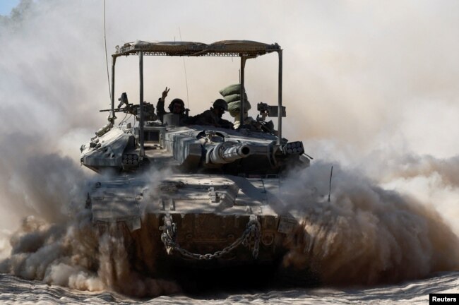 An Israeli tank maneuvres near the Israel-Gaza border, amid the Israel-Hamas conflict, July 2, 2024.