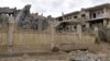 A damaged building is seen following an airstrike in Syria's eastern city of Deir el-Zour, March 26, 2024.