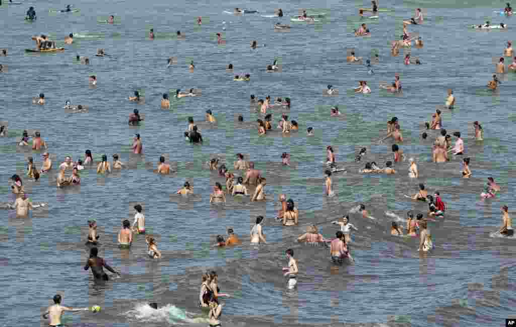 People enjoy the sea in Biarritz, southwestern France.