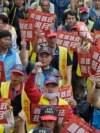 Taiwanese workers hold slogans reading 'Congress Amended the Law to Support Workers' Rights' and 'The Regime Has No Honeymoon'' during a May Day rally in Taipei, Taiwan, May 1, 2024. 