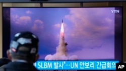 资料照片：2021 年 10 月 20 日，在韩国首尔的首尔火车站中播放的新闻节目中，一名男子正在观看电视屏幕上播放的朝鲜从潜艇发射导弹的画面。