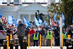 FILE - People protest for an extension and expansion of the Temporary Protected Status (TPS) program, Sept. 23, 2022, at Lafayette Park by the White House in Washington. (AP Photo/Jacquelyn Martin)