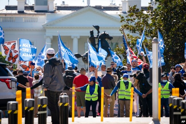 FILE - People protest for an extension and expansion of the Temporary Protected Status (TPS) program, Sept. 23, 2022, at Lafayette Park by the White House in Washington. (AP Photo/Jacquelyn Martin)