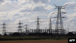 FILE - Electricity pylons are seen outside Keadby Power Station near Scunthorpe in northern England, Sept. 6, 2022.