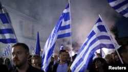 Supporters of Greek Prime Minister and leader of the conservative New Democracy ruling party Kyriakos Mitsotakis attend a pre-election rally in Athens, Greece, May 19, 2023.