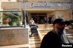 A man manuvers media equipment following an Israeli police raid on an Al Jazeera de facto office at the Ambassador Hotel in Jerusalem, May 5, 2024.