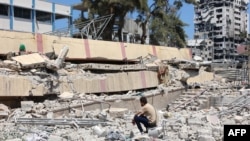 A man looks at the debris after an Israeli strike on a school, housing displaced Palestinians, in the Rimal neighborhood of central Gaza City on Aug. 20, 2024.