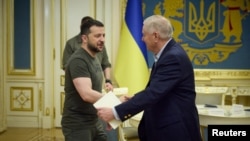 Ukraine's President Volodymyr Zelenskyy welcomes U.S. Senator Lindsey Graham before their meeting in Kyiv, May 26, 2023. (Ukrainian Presidential Press Service/Handout via Reuters)