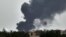 Smoke billows behind buildings from a reported fire in Khartoum, June 5, 2023, as fighting continues between two warring generals. 