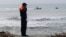 An Italian Coast Guard officer stands on a beach near Cutro, southern Italy, Feb. 28, 2023.