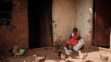 FILE - Faith, 3, who completed doses through the world's first malaria vaccine (RTS,S) pilot program, drinks tea at home in Mukuli, Kenya, on March 7, 2023.