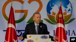 Turkish President Recep Tayyip Erdogan gestures as he speaks during a press conference at the conclusion of the G20 Summit, in New Delhi, India, Sept. 10, 2023.