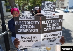 Demonstrators gather outside the parliament where former Eskom Chief Executive Officer Andre de Ruyter appears virtually before South African parliament's standing committee, in Cape Town, South Africa, April 26, 2023.