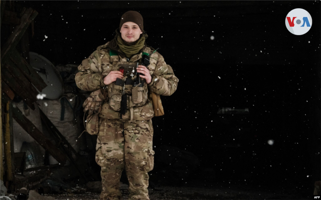 Un soldado de mortero examina el paisaje helado cerca de su refugio mientras cae la nieve.
