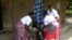 Eva Bulimpikya, center, with Soul Sisters members in action during a gender violence skit at Bundibugyo district, Western Uganda, June 29, 2024.