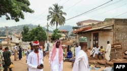 FILE - Muslim men walk in a street after attending Eid Al-Fitr prayers at the Tsinga Mosque in Yaounde, May 2, 2022.
