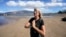 Anne Landon stands on a beach in Kihei, Hawaii, Aug. 15, 2023. The evacuation center at the South Maui Community Park Gymnasium is now her safe space, where she has a cot and access to food, water, showers, books and puzzles.