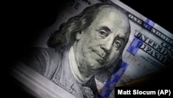 FILE - The likeness of Benjamin Franklin is seen on U.S. $100 bills, Thursday, July 14, 2022, in Marple Township, Pa. (AP Photo/Matt Slocum )