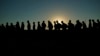 FILE - Migrants line up for processing by U.S. Customs and Border Protection, Sept. 23, 2023, in Eagle Pass, Texas. According to Customs and Border Protection, agents made 140,644 arrests of people trying to enter the country between legal border crossing points during February. 