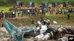 Nepal army personnel cordon off a plane crash site at Tribhuvan International Airport in Kathmandu, July 24, 2024. 