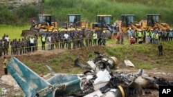 Nepal army personnel cordon off a plane crash site at Tribhuvan International Airport in Kathmandu, July 24, 2024.