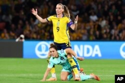 Sweden's Kosovare Asllani, top, reacts after a collision with Australia's Katrina Gorry during the Women's World Cup third place playoff soccer match between Australia and Sweden in Brisbane, Australia, Aug. 19, 2023.