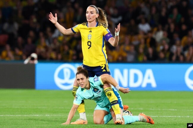 Sweden's Kosovare Asllani, top, reacts after a collision with Australia's Katrina Gorry during the Women's World Cup third place playoff soccer match between Australia and Sweden in Brisbane, Australia, Aug. 19, 2023.