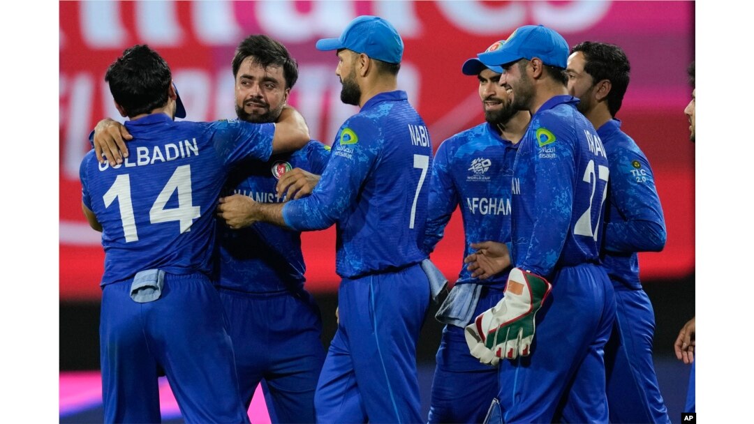 Afghanistan players celebrate after defeating Bangladesh by eight runs in their men's T20 World Cup cricket match at Arnos Vale Ground, Kingstown, Saint Vincent and the Grenadines, June 24, 2024.