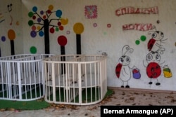 Empty cribs at a playhouse in the courtyard of Kherson regional children's home in Kherson on November 25, 2022. (Bernat Armangue/AP)