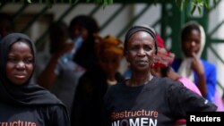 FILE - Women attend a protest against legislative bias against women on the International Women's Day in Abuja, Nigeria, March 8, 2022. 