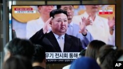 A TV screen shows an image of North Korean leader Kim Jong Un in July 2023.