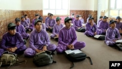 Afghan school boys attend their first class following the start of the new academic year, at a private school in Khost on March 20, 2024.