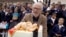 FILE — Colombian artist Fernando Botero laughs next to a cake decorated with a pastry made in the likeness of one of his sculptures during his 80th birthday celebration at the Botero Museum in Bogota, Colombia, April 19, 2012.
