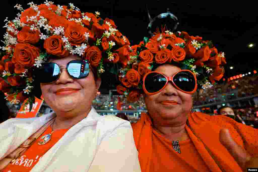 Supporters gesture as they attend a major rally event ahead of the upcoming election, in Bangkok, Thailand.