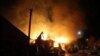 Petugas pemadam kebakaran berupaya memadamkan api setelah pertahanan udara menjatuhkan drone Ukraina, di Kursk, Rusia, 4 April 2024, dalam gambar yang diperoleh dari media sosial. (Gubernur Kursk Roman Starovoyt via Telegram/via Reuters)