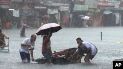 Streets flood from monsoon rains worsened by offshore Typhoon Gaemi in Manila, Philippines, July 24, 2024. The storm has already left several dead in the Philippines and is expected to drench China after passing over Taiwan.