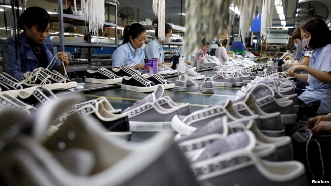 FILE - Employees work at a shoe factory for export in Hanoi, Vietnam December 29, 2020. (REUTERS/Kham/File Photo)