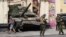 Russian servicemen guard an area standing in front of a tank in a street in Rostov-on-Don, Russia, June 24, 2023. 