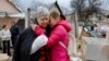 Una residente local herida en un reciente ataque es consolada por otra mujer frente a su casa destruida en la región ucraniana de Donetsk, controlada por Rusia, el 12 de marzo de 2023.