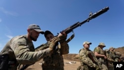 Servicemen of the newly created National Guard unit train in the Kharkiv region, Ukraine, June 1, 2023. 