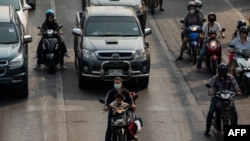 FILE - Motorists wear face masks amid high levels of air pollution in Chiang Mai in northern Thailand on March 10, 2023.