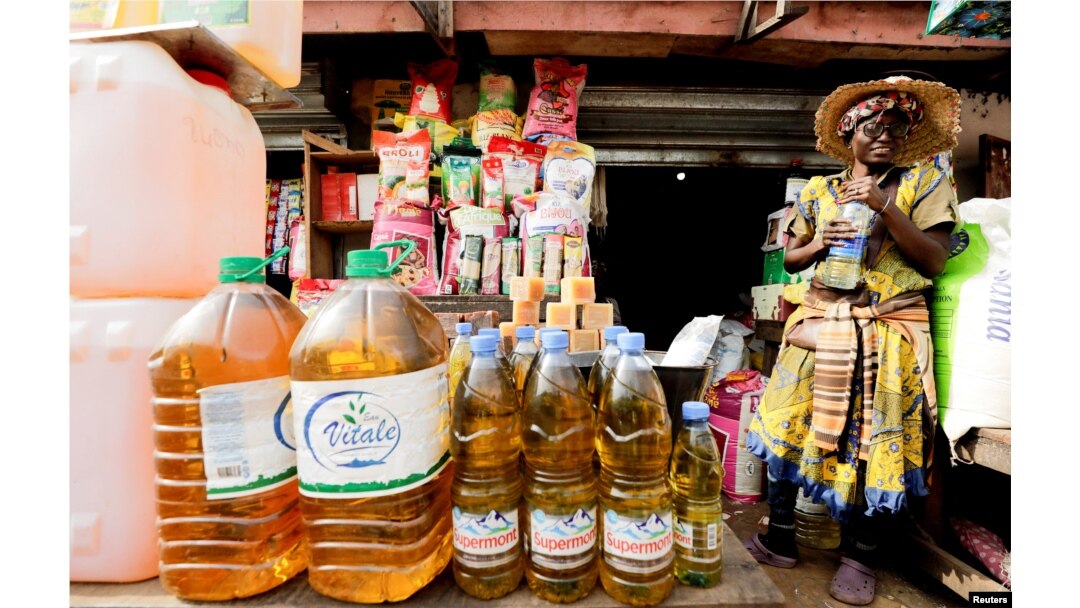 FILE - An oil vendor reacts at the Mvog Ada market in Yaounde, Cameroon, Jan. 29, 2022.