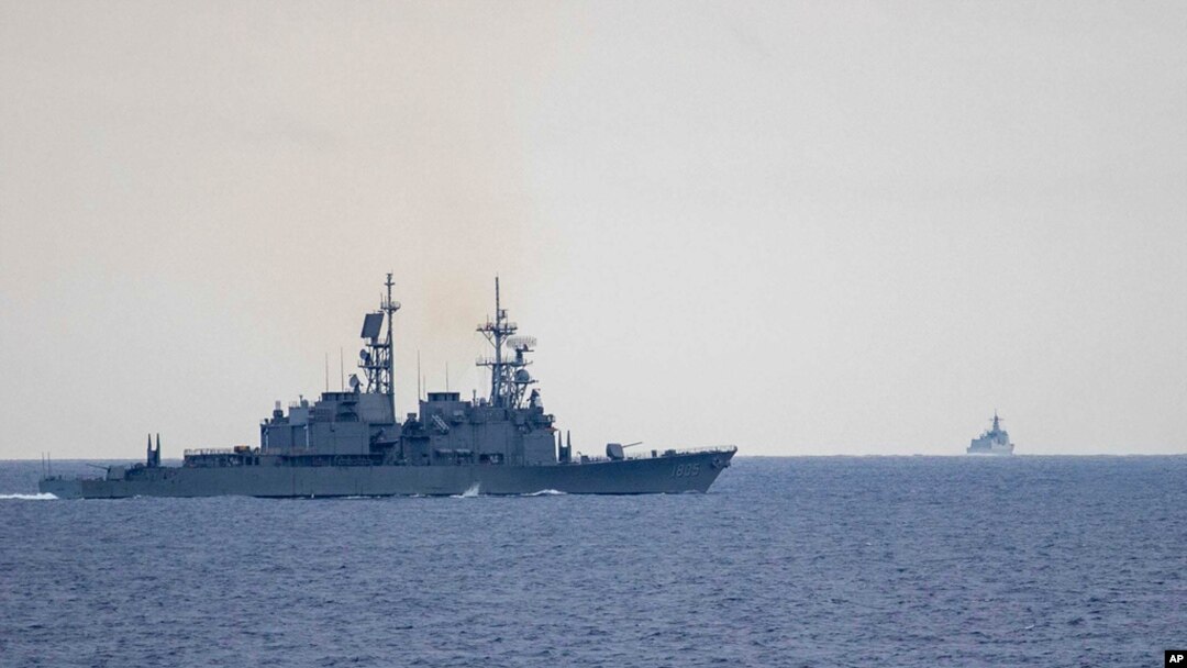 In this photo released by the Taiwan Ministry of National Defense, Taiwan guided missile destroyer Ma Kong DDG1805, left, monitors Chinese guided missile destroyer Xi'an DDG15, right, near Taiwan on May 23, 2024. 