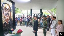 French President Emmanuel Macron pays homage to Bangladesh's independence leader Sheikh Mujibur Rahman at the Bangabandhu Memorial Museum in Dhaka, Sept.11, 2023. 