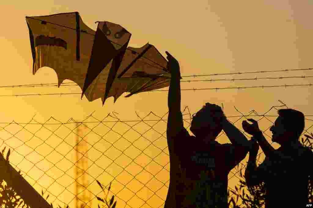 People take part in the annual kite festival at Abu Nawas park in Baghdad.