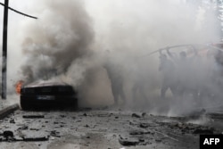 Lebanese firefighters put out a fire in a car after an Israeli strike in the southern city of Sidon, Aug. 21, 2024. An Israeli strike in Lebanon's southern city killed a Fatah official, said a leader from the Palestinian group.