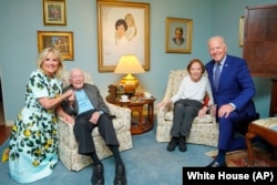 FILE - Former President Jimmy Carter and former first lady Rosalynn Carter pose for a photo with President Joe Biden and first lady Jill Biden at the Carters' home in Plains, Georgia, April 30, 2021.