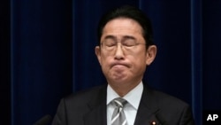 Japanese Prime Minister Fumio Kishida reacts as he speaks during a news conference in Tokyo, Dec. 13, 2023.