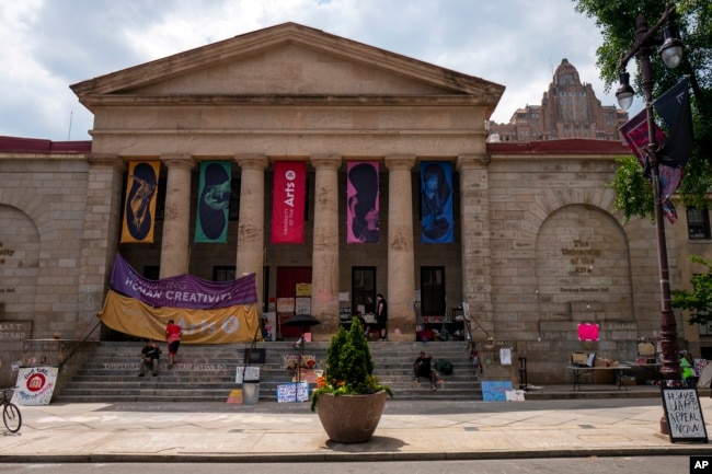 FILE - Signs and writing denouncing the closure of the University of the Arts are pictured at Dorrance Hamilton Hall on Friday, June 14, 2024, in Philadelphia. (AP Photo/Joe Lamberti)