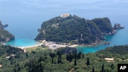 FILE - A portion of the west coast of Corfu is seen on in the Ionian Sea, May 29, 2005. The body of the man was found July 16, 2014, on a rocky and fairly remote beach on the nearby island of Mathraki.